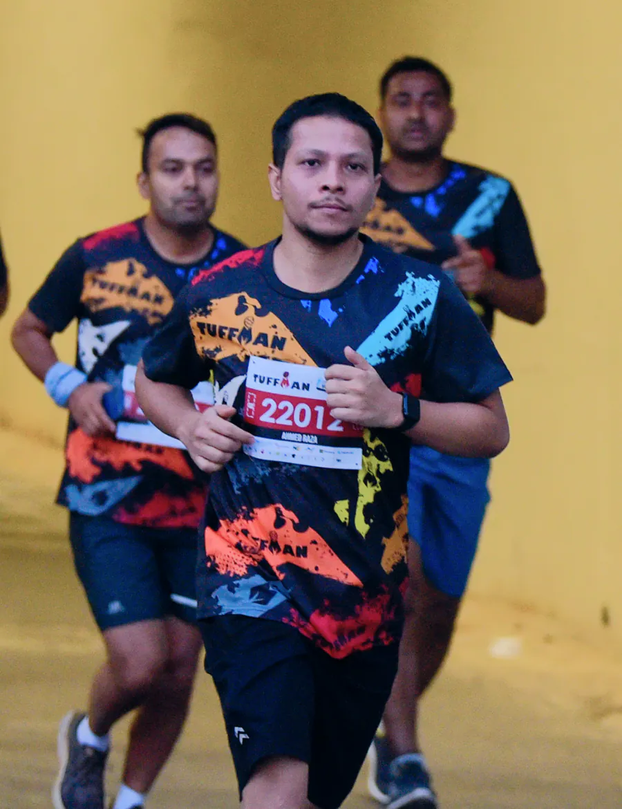 Running a Tuffman race, mid-stride in a pack of runners.