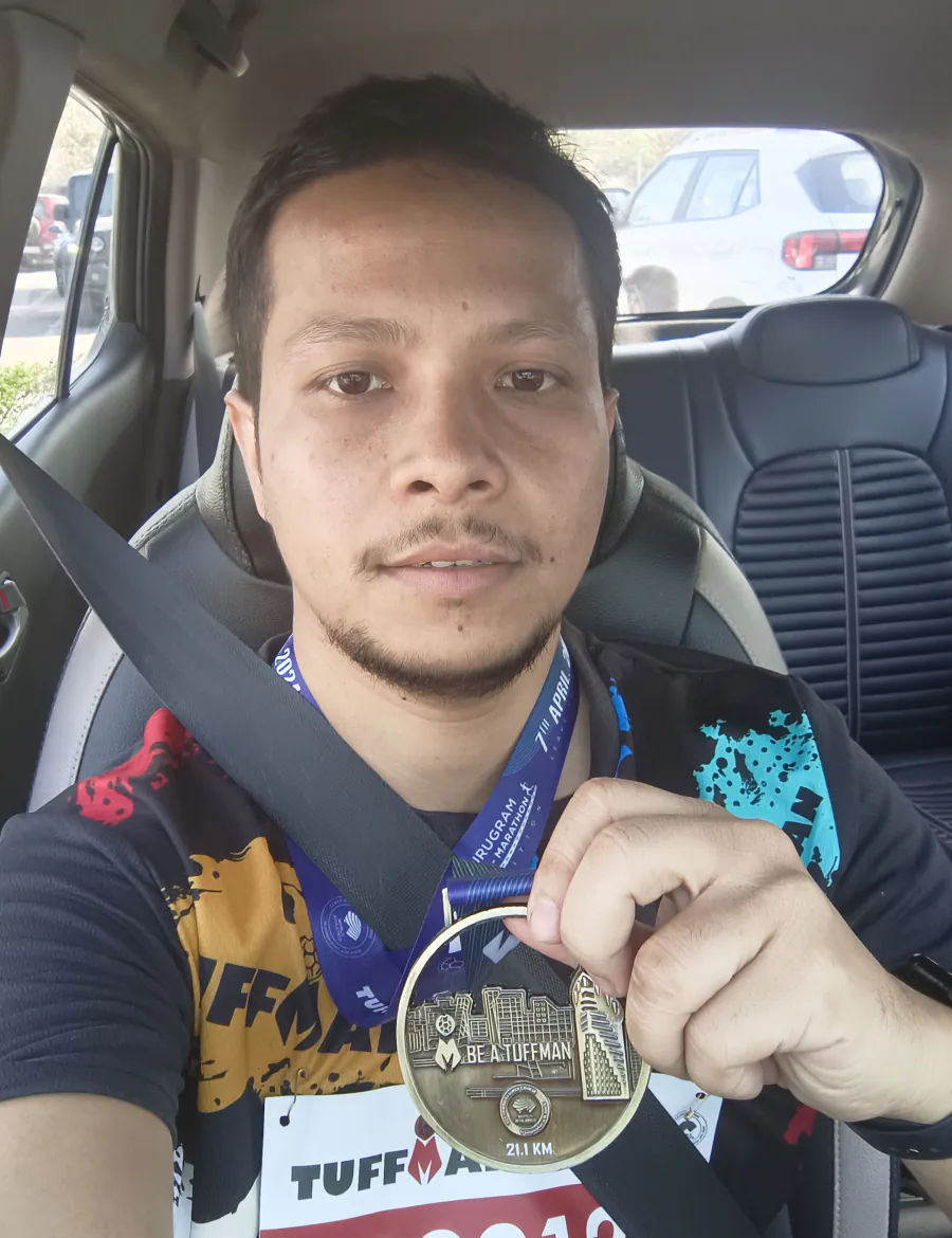Holding up the finisher medal in the car after that race.